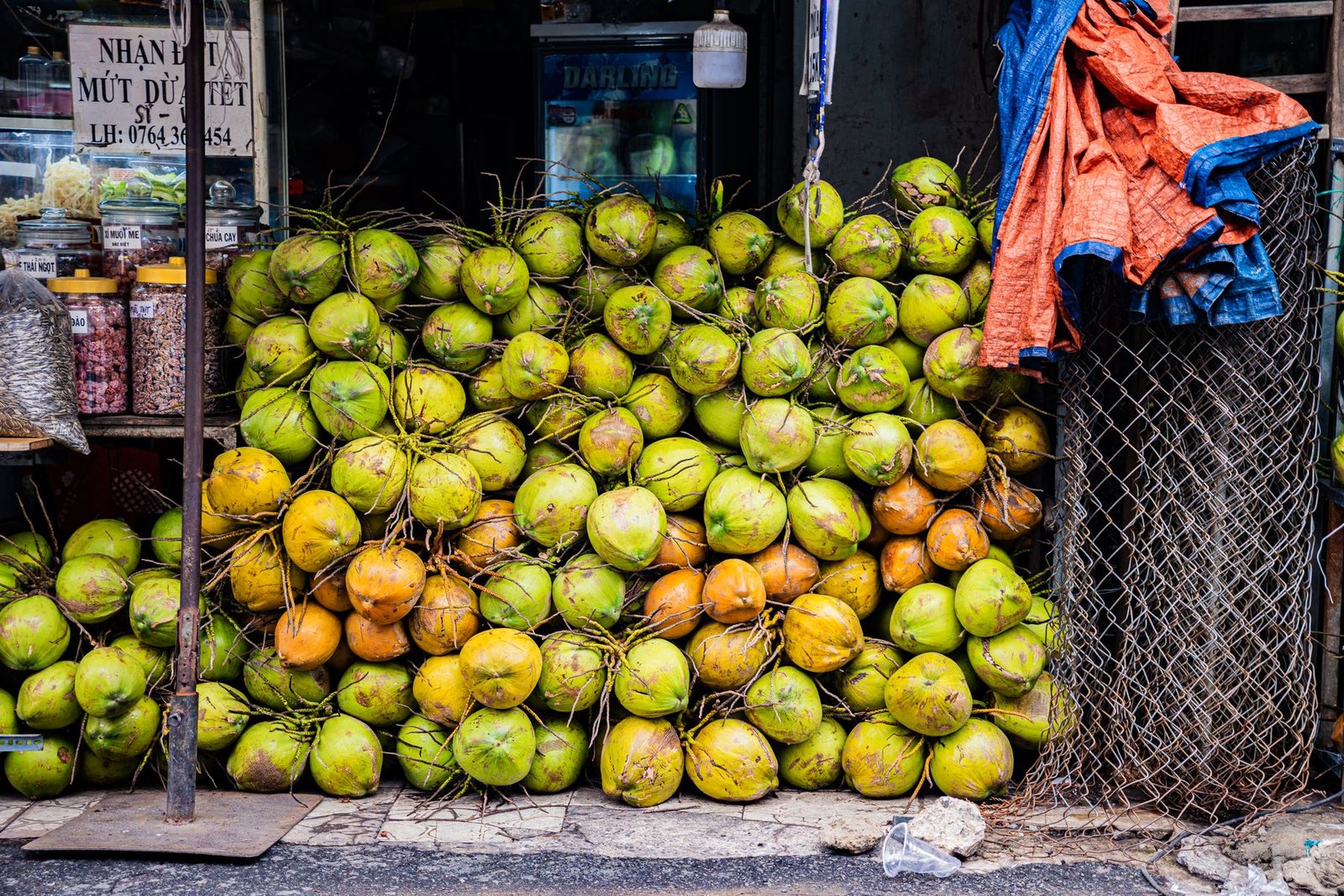A pile of fresh coconuts at a Vietnamese market